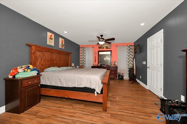 bedroom with ceiling fan and light hardwood / wood-style floors