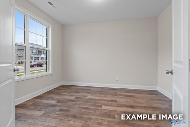 unfurnished room with dark wood-type flooring