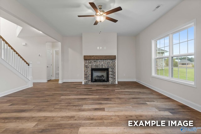 unfurnished living room with wood-type flooring and ceiling fan