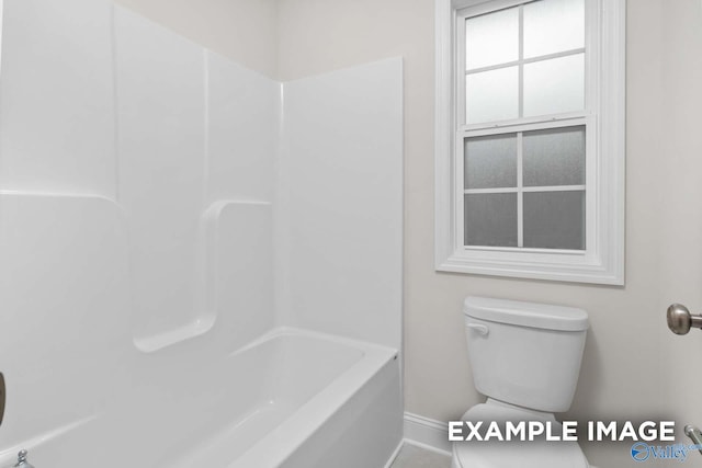 bathroom with toilet and washtub / shower combination