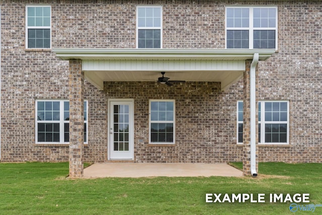 entrance to property featuring a patio, a lawn, and ceiling fan