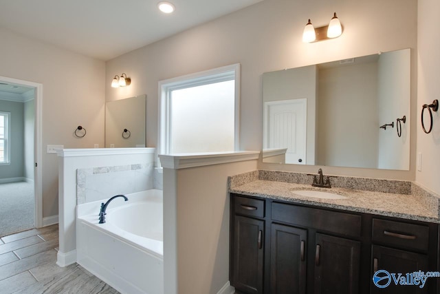 108 Ivy Vine Dr, Toney, AL 35773 - full bath with a garden tub, vanity, and baseboards