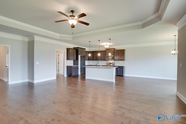 108 Ivy Vine Dr, Toney, AL 35773 - unfurnished living room featuring a ceiling fan, a raised ceiling, dark wood finished floors, crown molding, and baseboards