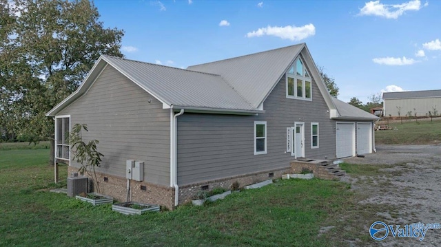 back of property with a yard, a garage, and cooling unit