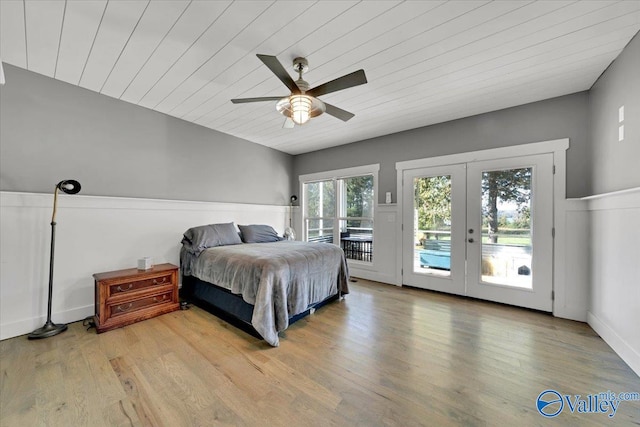 bedroom featuring ceiling fan, wood-type flooring, access to outside, and french doors