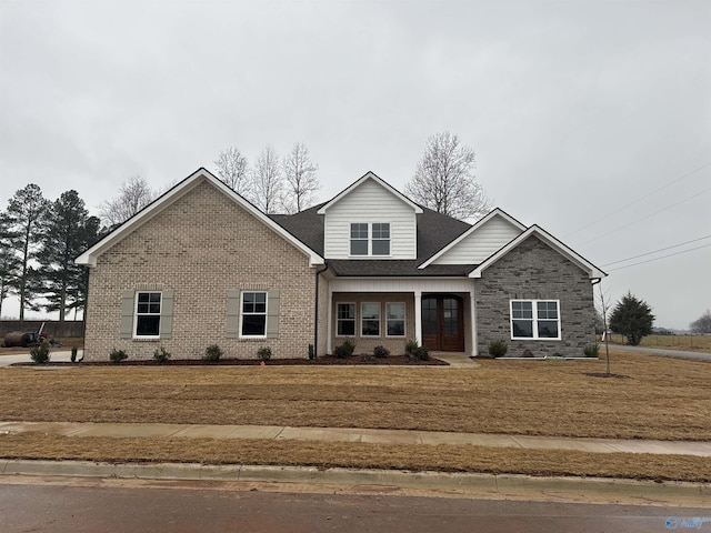 craftsman-style home with a front lawn and a porch