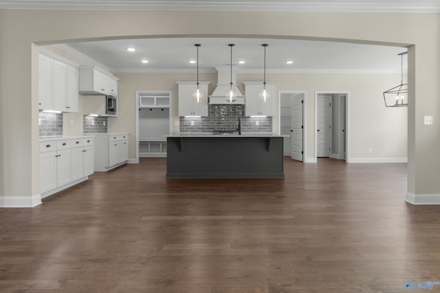 22541 Players Ln, Athens, AL 35613 - kitchen with hanging light fixtures, an island with sink, white cabinetry, and dark wood-type flooring