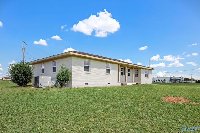 rear view of house with a yard