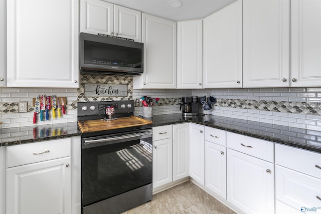 kitchen featuring white cabinets, decorative backsplash, light tile patterned floors, and electric stove