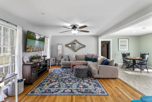 living room featuring hardwood / wood-style floors and ceiling fan