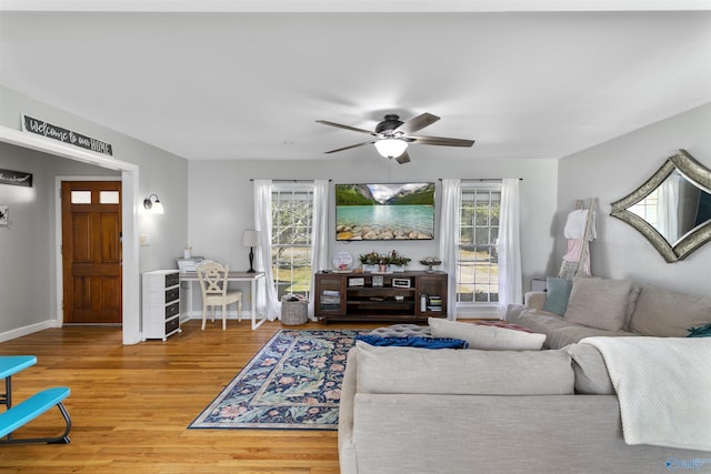 living room featuring wood-type flooring and ceiling fan