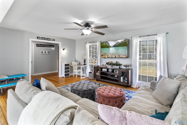 living room with hardwood / wood-style floors and ceiling fan