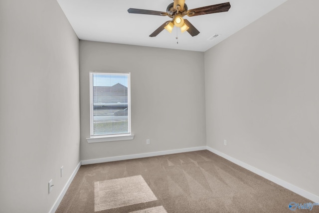 carpeted empty room featuring ceiling fan