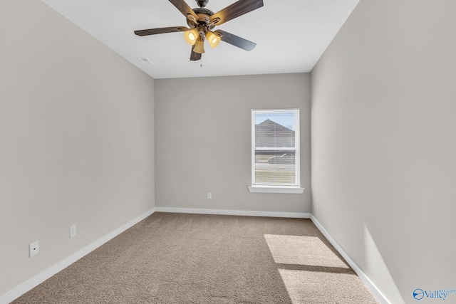 carpeted spare room with ceiling fan