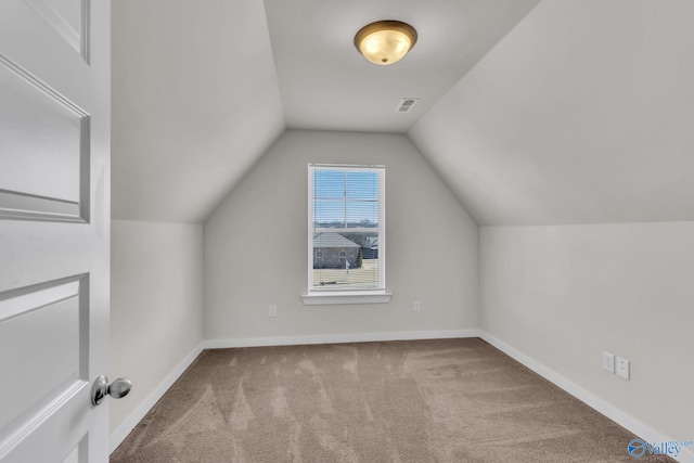 additional living space featuring lofted ceiling and carpet floors