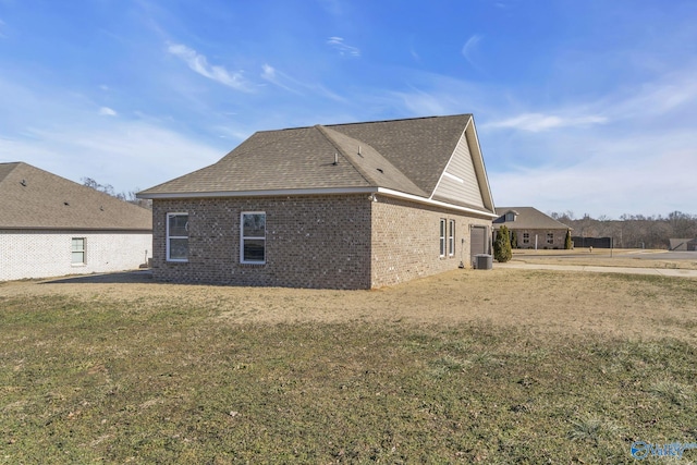 view of home's exterior featuring a lawn and central air condition unit