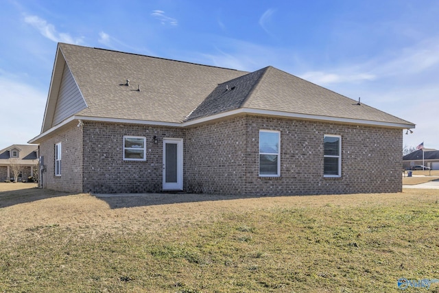 rear view of property with a yard