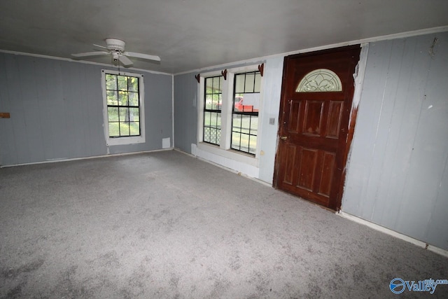 carpeted foyer entrance with ceiling fan