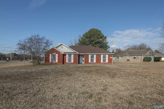 ranch-style home with a front lawn