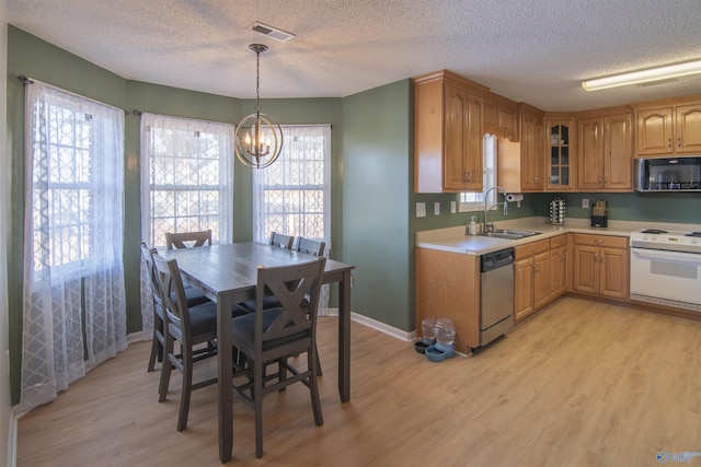 kitchen featuring pendant lighting, white range with electric stovetop, sink, stainless steel dishwasher, and light hardwood / wood-style floors