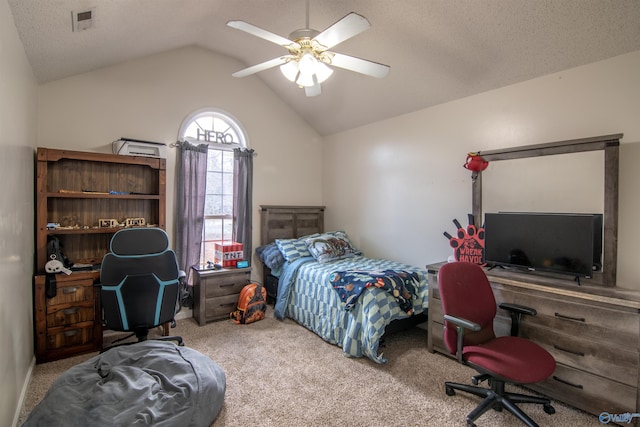 carpeted bedroom with vaulted ceiling, a textured ceiling, and ceiling fan