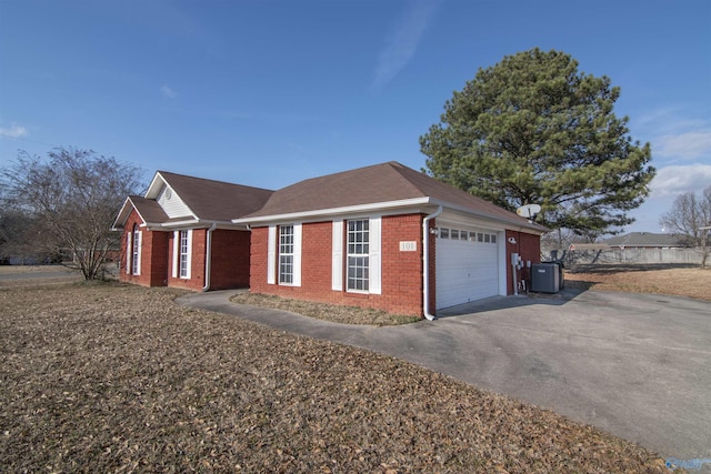 view of side of home featuring a garage and central air condition unit