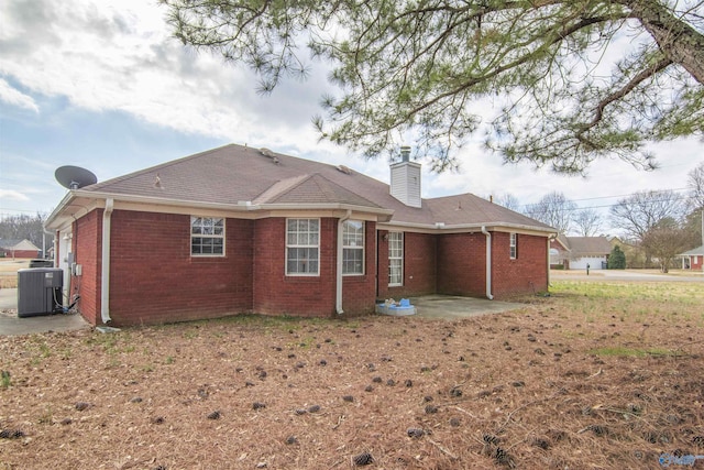 back of property featuring central AC and a patio