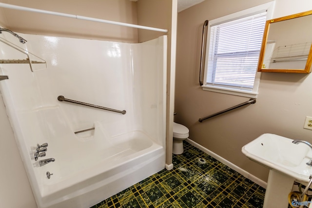 full bathroom with sink, bathtub / shower combination, and toilet