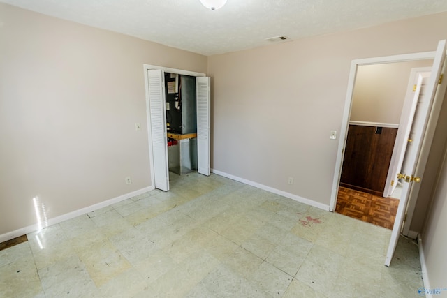 unfurnished bedroom featuring a closet and a textured ceiling