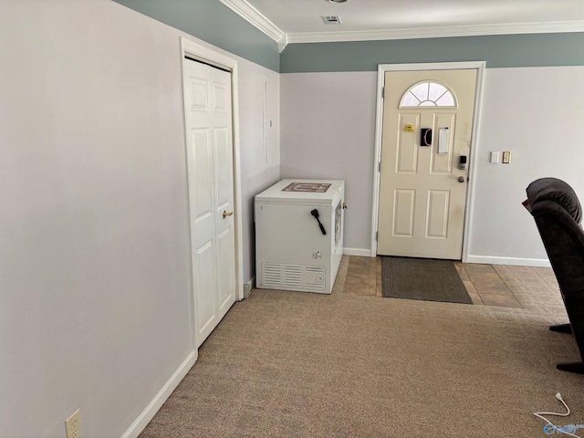 carpeted entryway with ornamental molding, visible vents, and baseboards