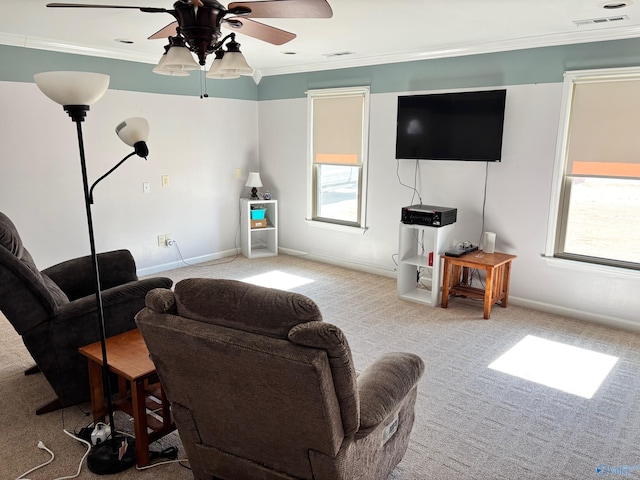 carpeted living room featuring a healthy amount of sunlight, visible vents, and crown molding