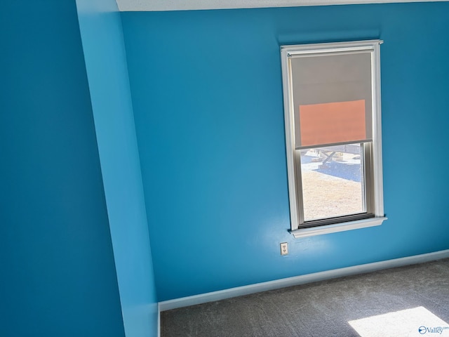 carpeted spare room with baseboards