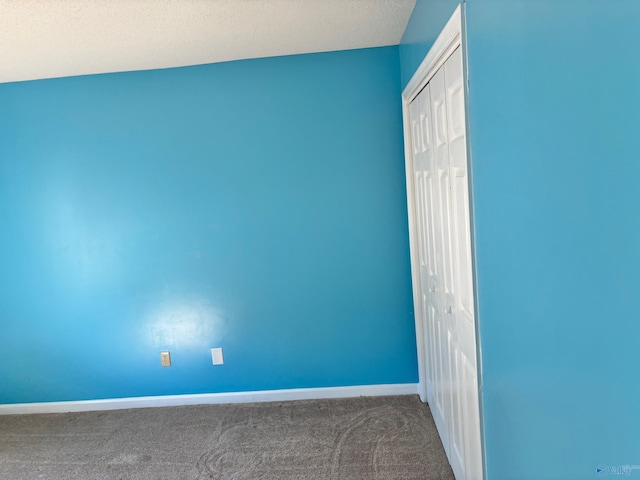 carpeted spare room with baseboards