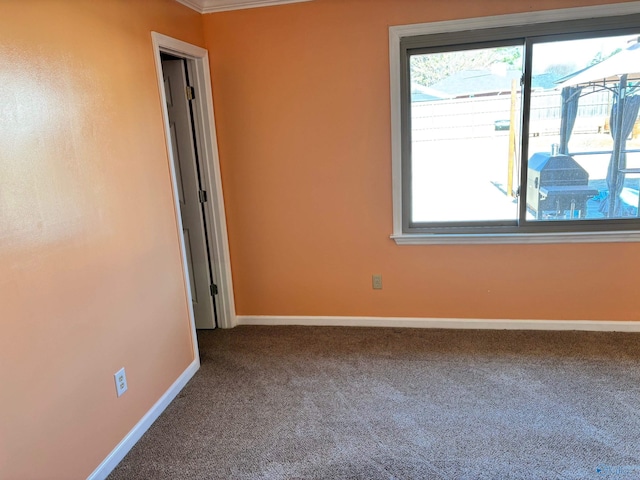 unfurnished room with carpet and baseboards