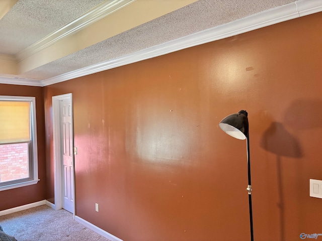 unfurnished room with crown molding, baseboards, a textured ceiling, and carpet flooring