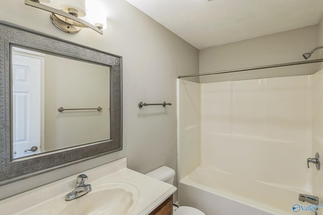 full bathroom featuring vanity, toilet, and  shower combination