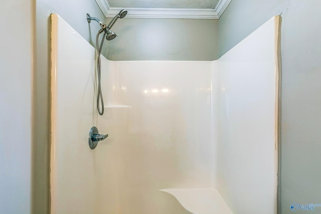 bathroom featuring walk in shower, a textured ceiling, and ornamental molding