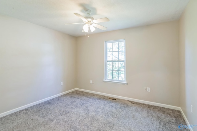 carpeted spare room with ceiling fan