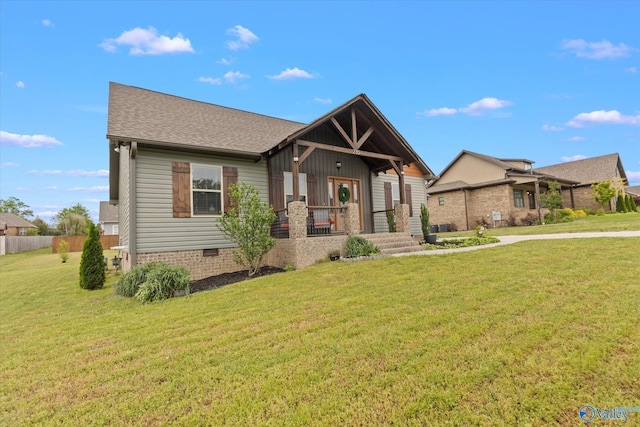 craftsman house featuring a porch and a front lawn