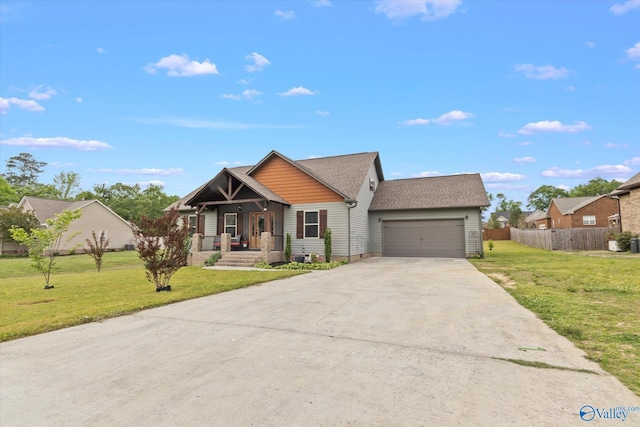 view of front facade featuring a porch, a garage, and a front lawn