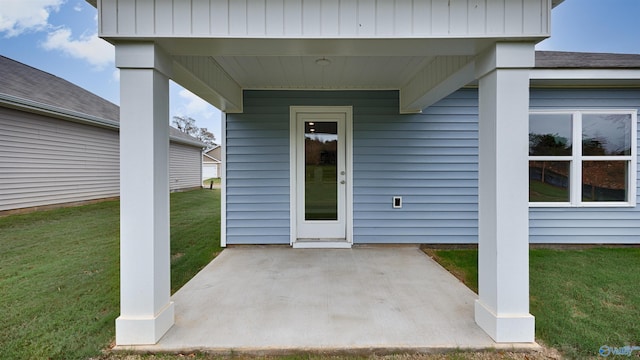 entrance to property featuring a lawn