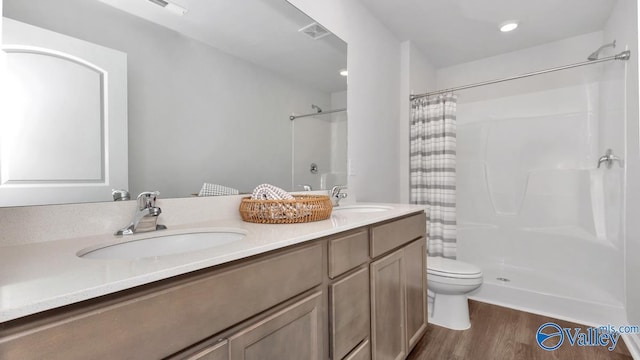 bathroom with wood-type flooring, toilet, vanity, and a shower with shower curtain