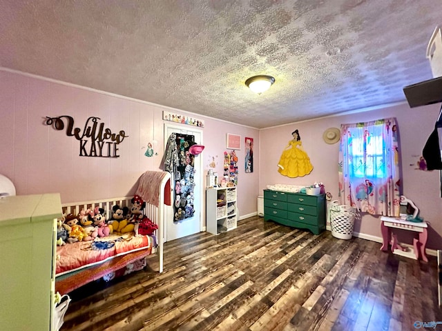 bedroom with dark hardwood / wood-style floors and a textured ceiling