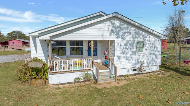 bungalow-style house featuring covered porch and a front yard