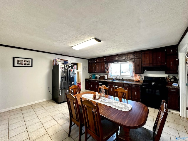 tiled dining room featuring crown molding, sink, and a textured ceiling