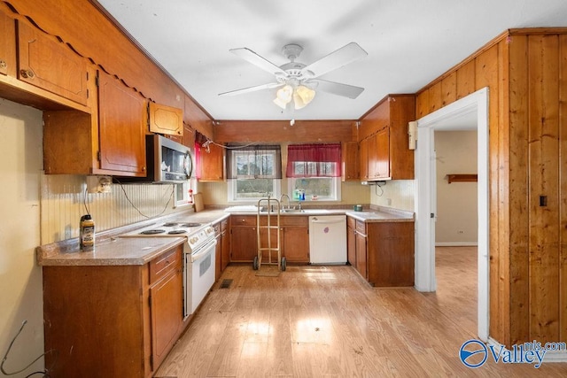 kitchen with ceiling fan, sink, white appliances, and light hardwood / wood-style floors