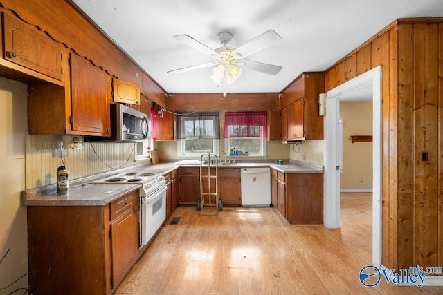 kitchen with ceiling fan, white appliances, and light hardwood / wood-style flooring