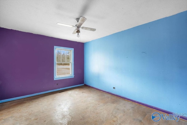 empty room with ceiling fan and concrete floors