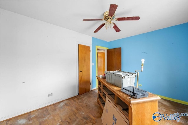 office area with dark wood-type flooring and ceiling fan