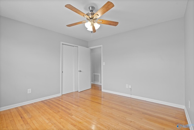 unfurnished bedroom with ceiling fan, light hardwood / wood-style floors, and a closet